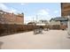The patio has a cement floor, a wooden fence, and metal tables and chairs at 1365 Columbine St # 301, Denver, CO 80206