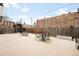 This is a cement patio with tables, chairs, and a wooden fence at 1365 Columbine St # 301, Denver, CO 80206