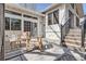 Outdoor patio area with seating, adjacent to sliding glass doors and stairs at 7998 S Wabash Ct, Centennial, CO 80112
