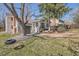 Expansive backyard featuring a tire swing, mature trees, and landscaped areas at 7998 S Wabash Ct, Centennial, CO 80112