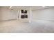 Finished basement with kitchenette, doors to storage, and plush carpeting at 7998 S Wabash Ct, Centennial, CO 80112