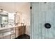 Beautiful bathroom features double vanities, black hexagon tile flooring and a glass door shower at 7998 S Wabash Ct, Centennial, CO 80112