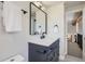 Chic bathroom featuring gray vanity with marble countertop, and black framed mirror at 7998 S Wabash Ct, Centennial, CO 80112
