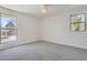 Bright bedroom featuring two large windows and neutral carpeting at 7998 S Wabash Ct, Centennial, CO 80112