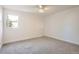 Bright bedroom featuring a large window and neutral carpeting at 7998 S Wabash Ct, Centennial, CO 80112