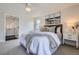 Comfortable bedroom with a large bed, soft carpet, neutral tones, and an adjacent bathroom at 7998 S Wabash Ct, Centennial, CO 80112