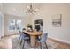 Bright dining room featuring wood floors, modern light fixture, vaulted ceiling, and staircase views at 7998 S Wabash Ct, Centennial, CO 80112