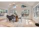 Sunny dining area with modern lighting, a wood table, and sliding doors to the patio at 7998 S Wabash Ct, Centennial, CO 80112