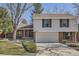 Charming two-story home with brick and white siding, complemented by a two-car garage and professionally landscaped yard at 7998 S Wabash Ct, Centennial, CO 80112