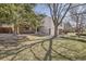 A well-maintained home exterior featuring green lawns and mature trees, showcasing the property's curb appeal and landscaping at 7998 S Wabash Ct, Centennial, CO 80112