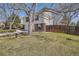 Beautiful home exterior with brick accents and a lush yard, complemented by mature trees and a wood fence at 7998 S Wabash Ct, Centennial, CO 80112
