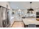 Updated kitchen featuring stainless steel appliances, quartz counters, white cabinets, and tile backsplash at 7998 S Wabash Ct, Centennial, CO 80112