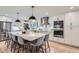 Spacious kitchen boasts quartz counters, stainless appliances, island seating, and modern lighting at 7998 S Wabash Ct, Centennial, CO 80112