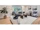 Bright living room with a large window, stylish furnishings, and hardwood floors at 7998 S Wabash Ct, Centennial, CO 80112
