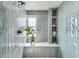 Stylish shower features green tile, a built-in shelf, and a window that brightens the space at 7998 S Wabash Ct, Centennial, CO 80112