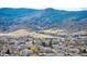 High altitude aerial view of a planned community bordering open space with mountains in the distance at 8346 Mount Kataka St, Littleton, CO 80125