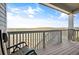 Back porch with rocking chair and wood flooring overlooking open space and rolling hills at 8346 Mount Kataka St, Littleton, CO 80125