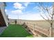 Turf backyard with rock groundcover featuring a split rail fence bordering open space at 8346 Mount Kataka St, Littleton, CO 80125