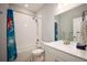 Bright bathroom featuring a white vanity, sink, and tub/shower combo with playful themed shower curtain at 8346 Mount Kataka St, Littleton, CO 80125