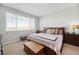 Serene bedroom featuring a large window, soft carpet, and comfortable furnishings at 8346 Mount Kataka St, Littleton, CO 80125