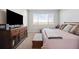 Bedroom featuring a media center and storage, a large window offering plenty of natural light at 8346 Mount Kataka St, Littleton, CO 80125