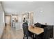 Open dining area with views of the kitchen featuring stainless steel appliances and white cabinets at 8346 Mount Kataka St, Littleton, CO 80125