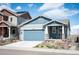 Inviting home with a well-manicured lawn, covered porch, and attached two-car garage at 8346 Mount Kataka St, Littleton, CO 80125