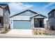 Exterior elevation of a house with a two-car garage and modern architecture at 8346 Mount Kataka St, Littleton, CO 80125