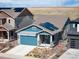 Exterior elevation featuring solar panels on the roof and an attached two-car garage at 8346 Mount Kataka St, Littleton, CO 80125