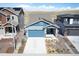 Aerial view of a cozy blue house with solar panels, landscaping, and an attached garage at 8346 Mount Kataka St, Littleton, CO 80125