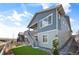 Charming home with a private entrance, blue siding, white trim and a cozy, inviting outdoor space at 8346 Mount Kataka St, Littleton, CO 80125