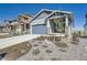 Charming blue two-story home features a well-manicured front yard and attached two-car garage at 8346 Mount Kataka St, Littleton, CO 80125