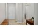 Bright hallway with wood-look flooring, white walls, and white doors leading to various rooms at 8346 Mount Kataka St, Littleton, CO 80125