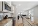 Modern kitchen with stainless appliances and granite countertops with an open floorplan at 8346 Mount Kataka St, Littleton, CO 80125