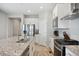 Bright kitchen features stainless steel appliances, granite counters and modern white cabinetry at 8346 Mount Kataka St, Littleton, CO 80125