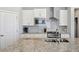 Modern kitchen with stainless appliances, granite countertops and white subway tile backsplash at 8346 Mount Kataka St, Littleton, CO 80125