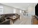 Spacious living room featuring a comfortable leather sectional sofa, wood floors, and ample natural light at 8346 Mount Kataka St, Littleton, CO 80125
