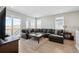 Cozy living room boasts a large sectional couch and access to an outdoor patio space at 8346 Mount Kataka St, Littleton, CO 80125