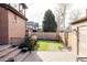 Brick patio, fenced yard, and grassy lawn at 1275 S Elizabeth St, Denver, CO 80210