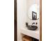 Modern powder room with unique vessel sink and organic-shaped mirror at 1275 S Elizabeth St, Denver, CO 80210