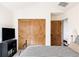 Cozy bedroom with wood closet doors and TV at 1275 S Elizabeth St, Denver, CO 80210