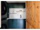 Spacious laundry room with dark green cabinetry and quartz countertops at 1275 S Elizabeth St, Denver, CO 80210