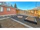 Charming backyard featuring brick patio, fire pit, garden beds, and wood privacy fence at 5211 W 4Th Ave # C, Lakewood, CO 80226