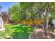 Expansive backyard featuring a lush lawn, mature trees, and a charming patio area perfect for outdoor entertaining at 930 Kearney St, Denver, CO 80220