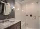 Modern bathroom features a glass shower with white subway tile and gray vanity with granite top at 930 Kearney St, Denver, CO 80220