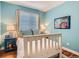 Bright bedroom featuring hardwood floors, modern decor and a large window at 930 Kearney St, Denver, CO 80220