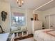 Cozy bedroom with canopy bed, window seat, and natural light at 930 Kearney St, Denver, CO 80220