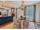 Cozy dining room featuring modern lighting fixture with hardwood floors and large windows at 930 Kearney St, Denver, CO 80220