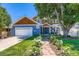 Charming two-story home with blue siding, a landscaped yard, and a welcoming front porch at 930 Kearney St, Denver, CO 80220