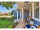 Cozy front porch features a wooden deck, comfortable seating and a hanging flower basket at 930 Kearney St, Denver, CO 80220